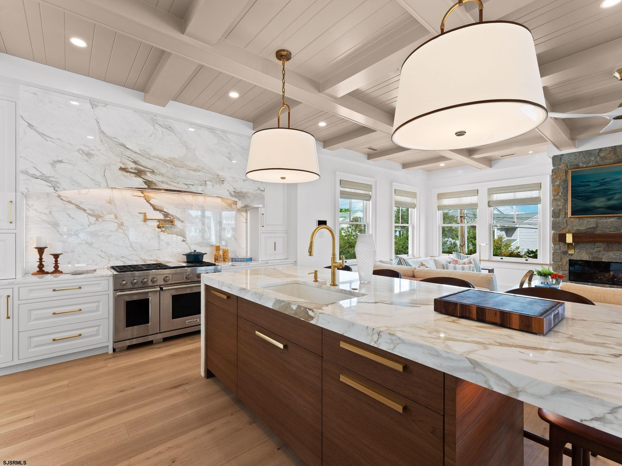 12 East Newcastle Road Ocean City, NJ 08226 - Photo 21 of 99 a kitchen with stainless steel appliances granite countertop a sink a stove and a wooden floors