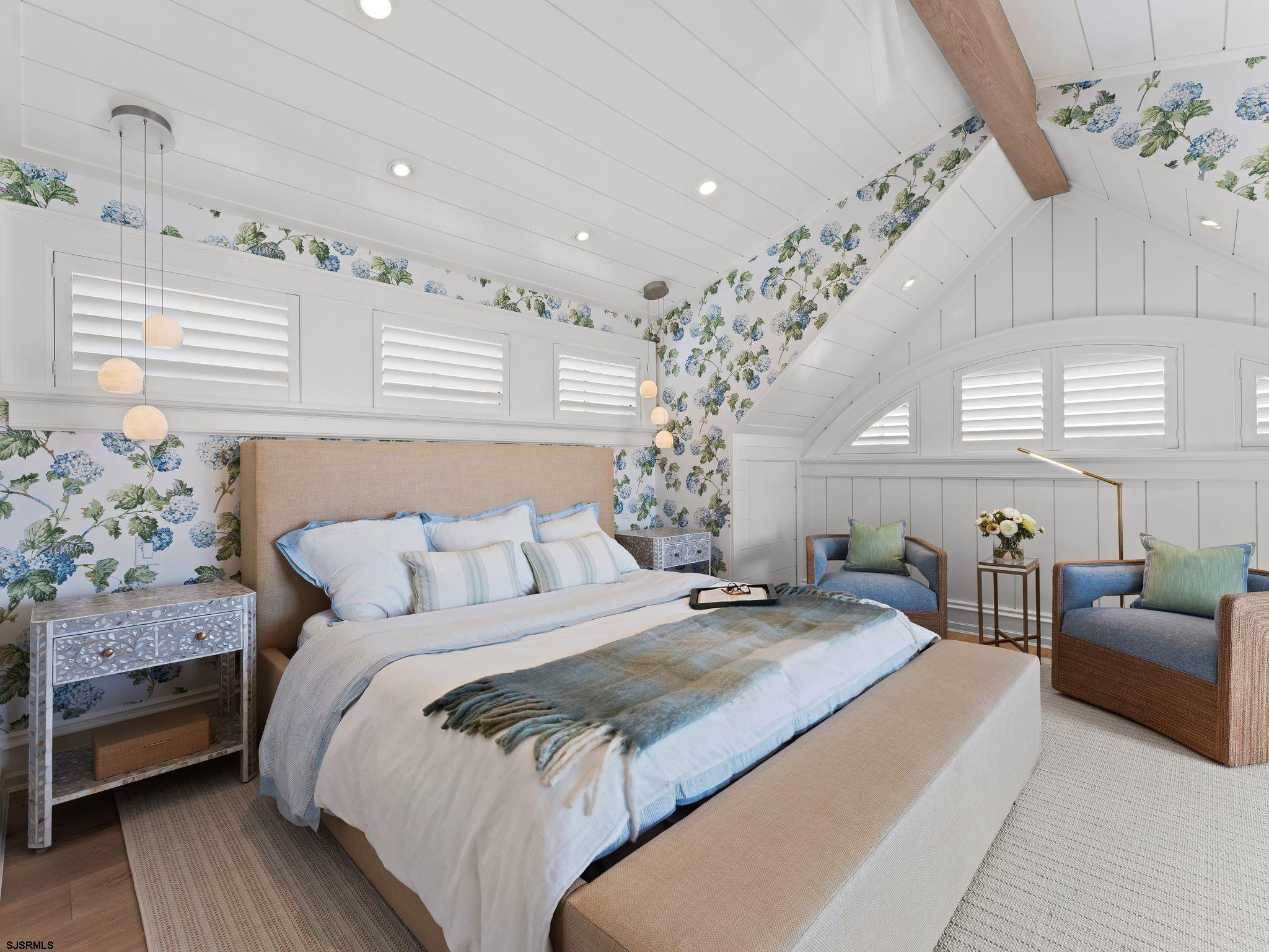 12 East Newcastle Road Ocean City, NJ 08226 - Photo 39 of 99 a bedroom with a large bed and a chandelier