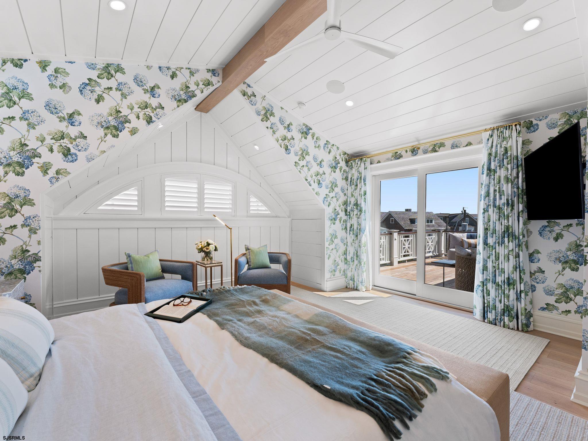 12 East Newcastle Road Ocean City, NJ 08226 - Photo 41 of 99 a bedroom with furniture large window and flat screen tv