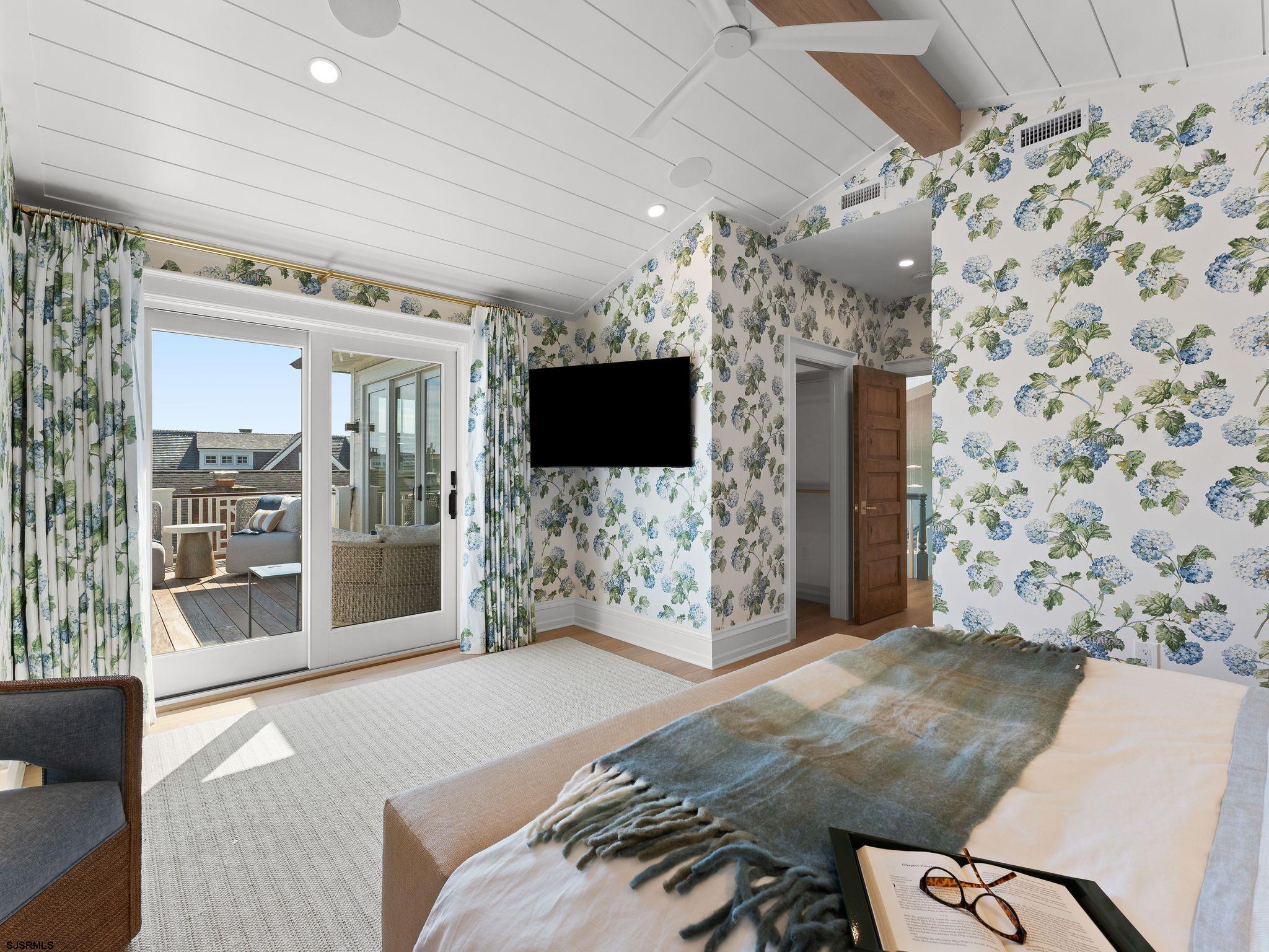 12 East Newcastle Road Ocean City, NJ 08226 - Photo 42 of 99 a spacious bedroom with a bed and flat screen tv