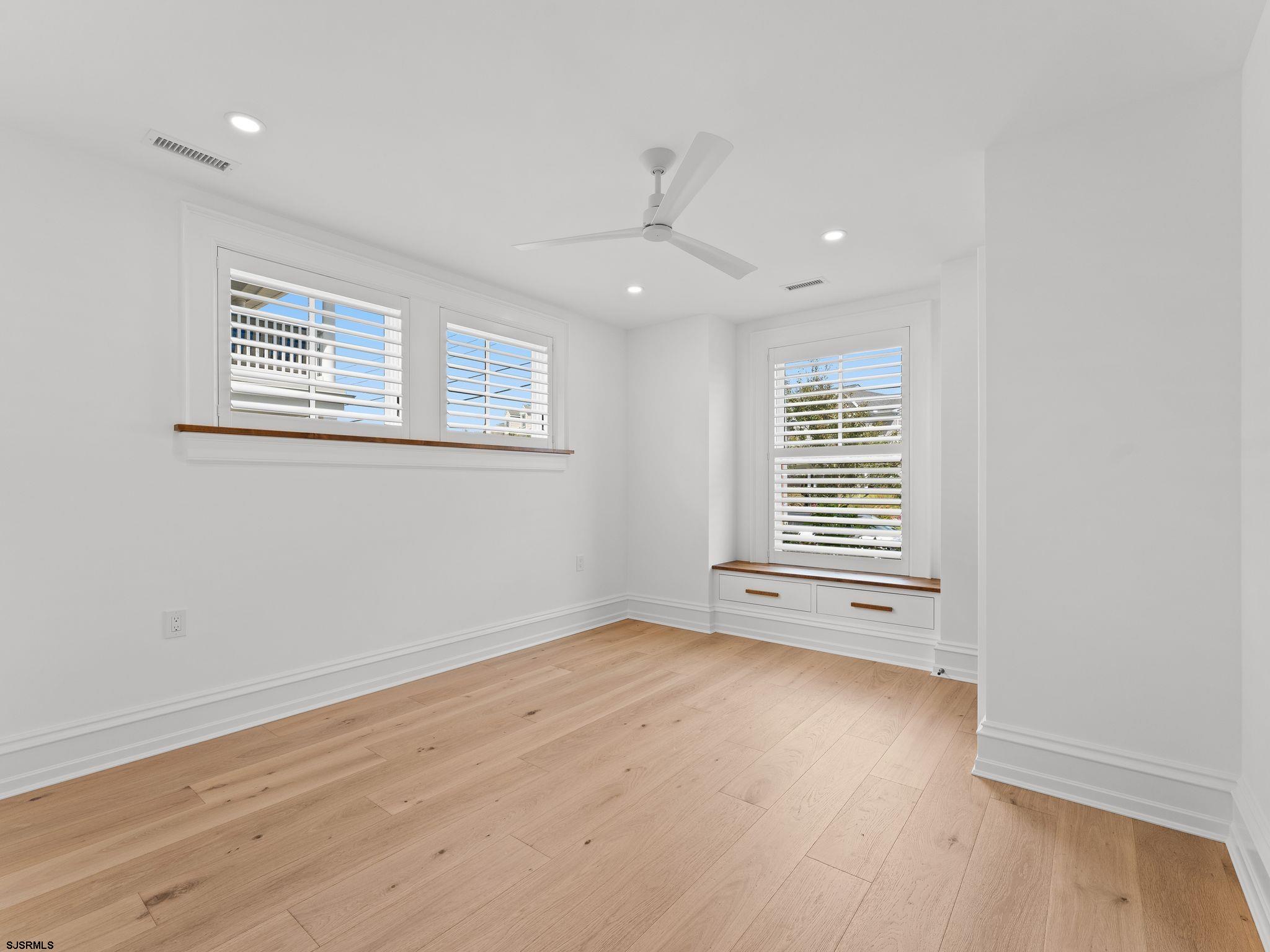 12 East Newcastle Road Ocean City, NJ 08226 - Photo 65 of 99 a view of an empty room with wooden floor and a window