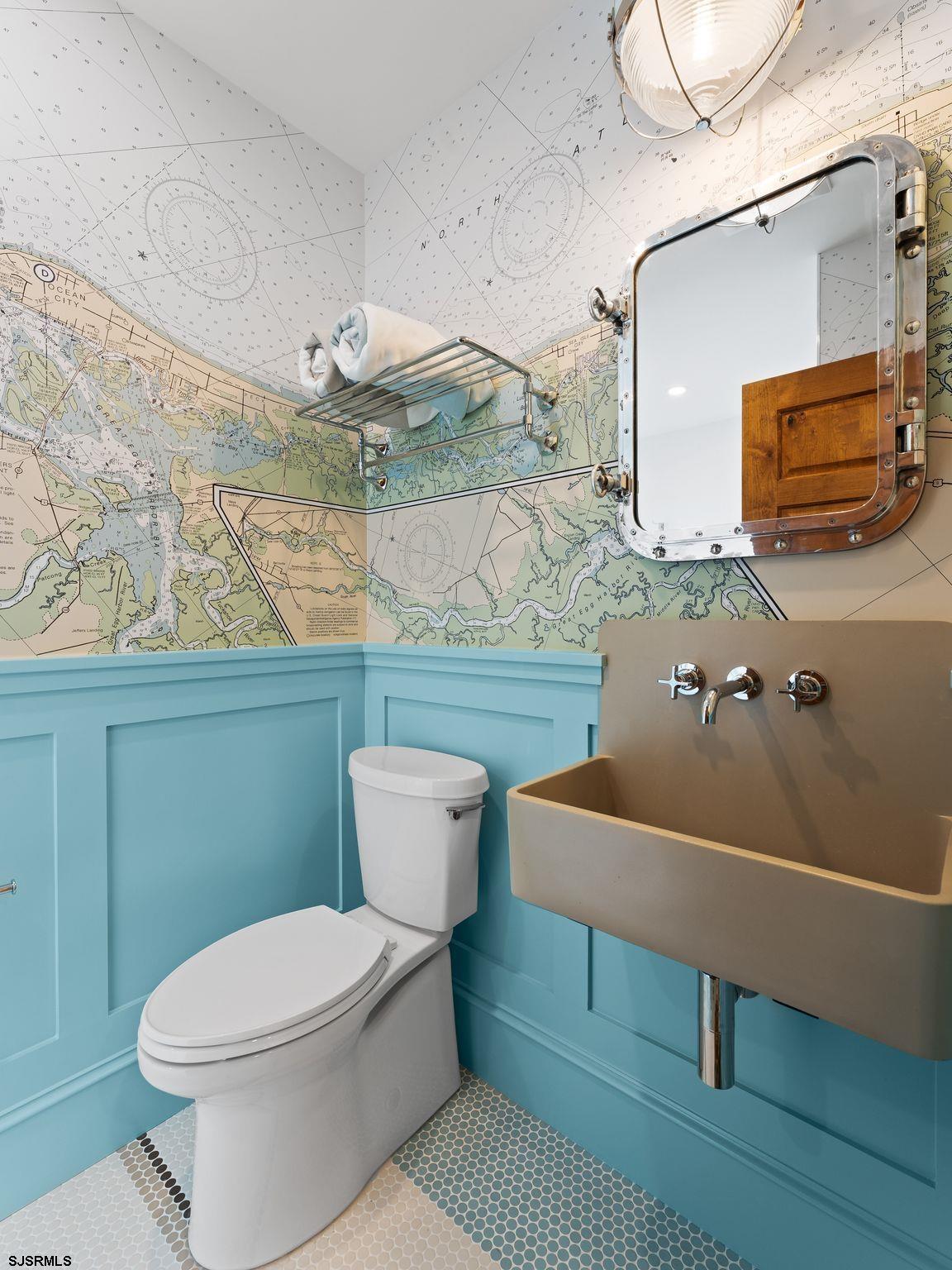 12 East Newcastle Road Ocean City, NJ 08226 - Photo 69 of 99 a bathroom with a toilet a sink and mirror