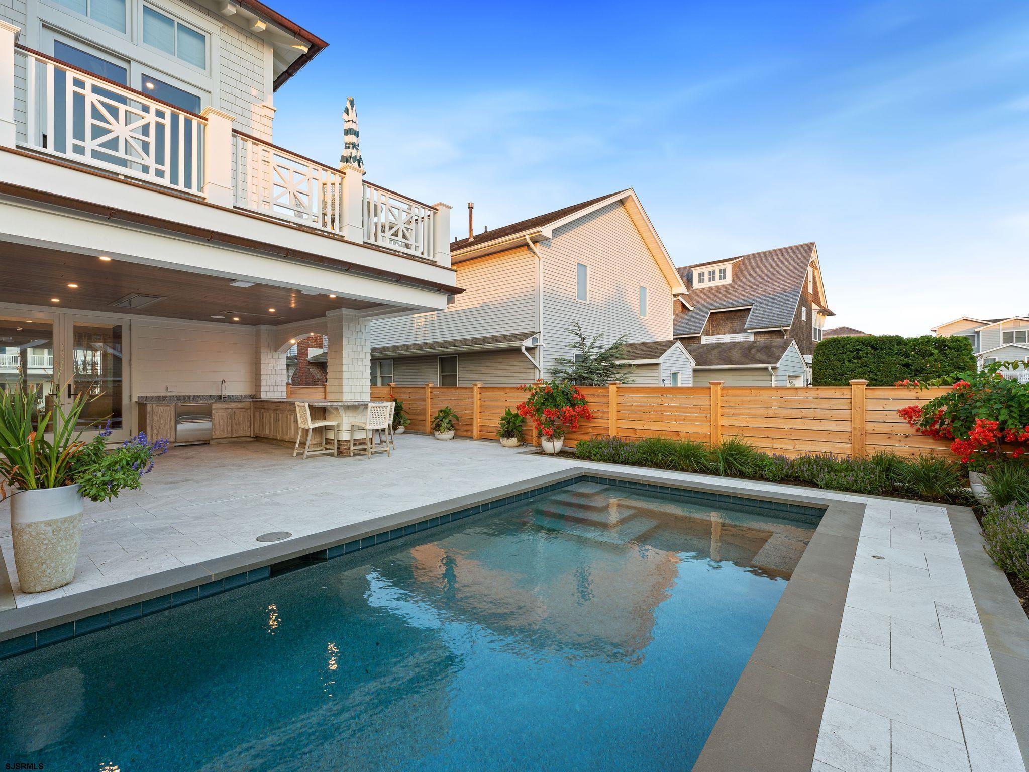 12 East Newcastle Road Ocean City, NJ 08226 - Photo 75 of 99 a view of a swimming pool with a lounge chairs