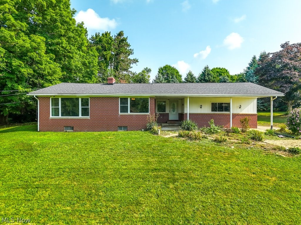 7105 Infirmary Road Ravenna, OH 44266 - Photo 2 of 33 Ranch-style home featuring a porch and a front lawn