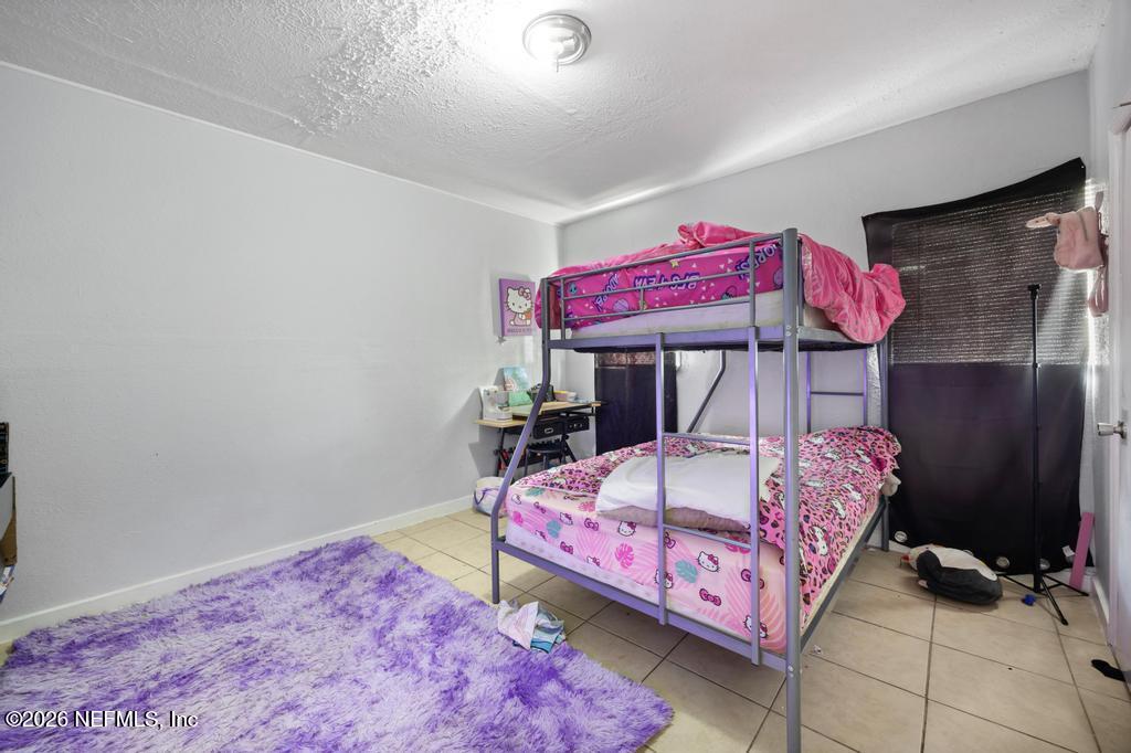 5210 Dodge Road Jacksonville, FL 32209 - Photo 13 of 42 a bedroom with a bed and a bed