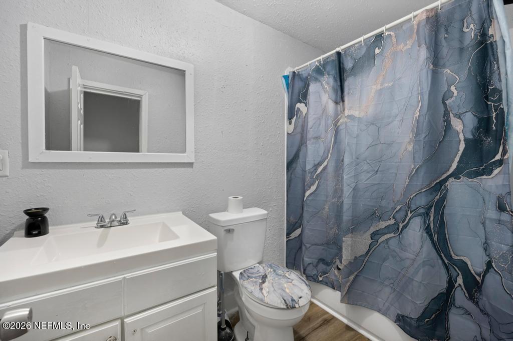 5210 Dodge Road Jacksonville, FL 32209 - Photo 14 of 42 a bathroom with a sink toilet and shower
