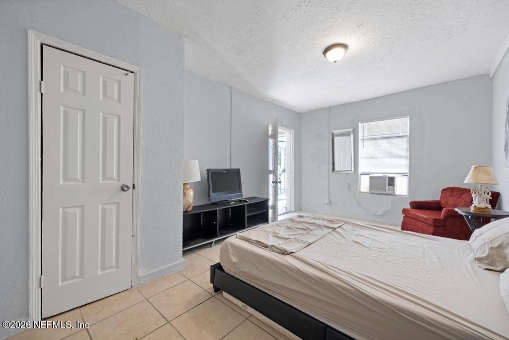 5210 Dodge Road Jacksonville, FL 32209 - Photo 21 of 42 a bedroom with a bed and a television