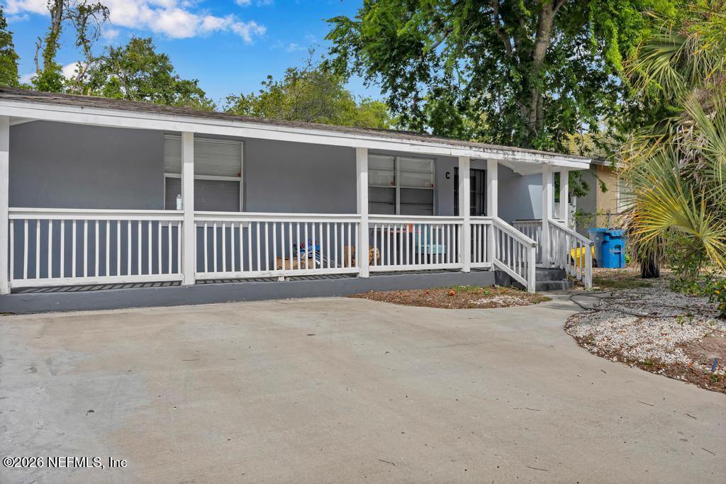 5210 Dodge Road Jacksonville, FL 32209 - Photo 7 of 42 a view of a house with a yard and potted plants