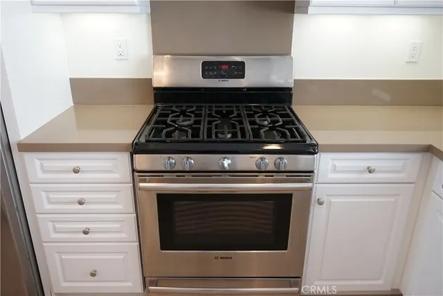 a stove top oven sitting inside of a kitchen