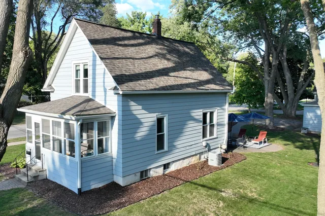 a view of a house with a yard and sitting area
