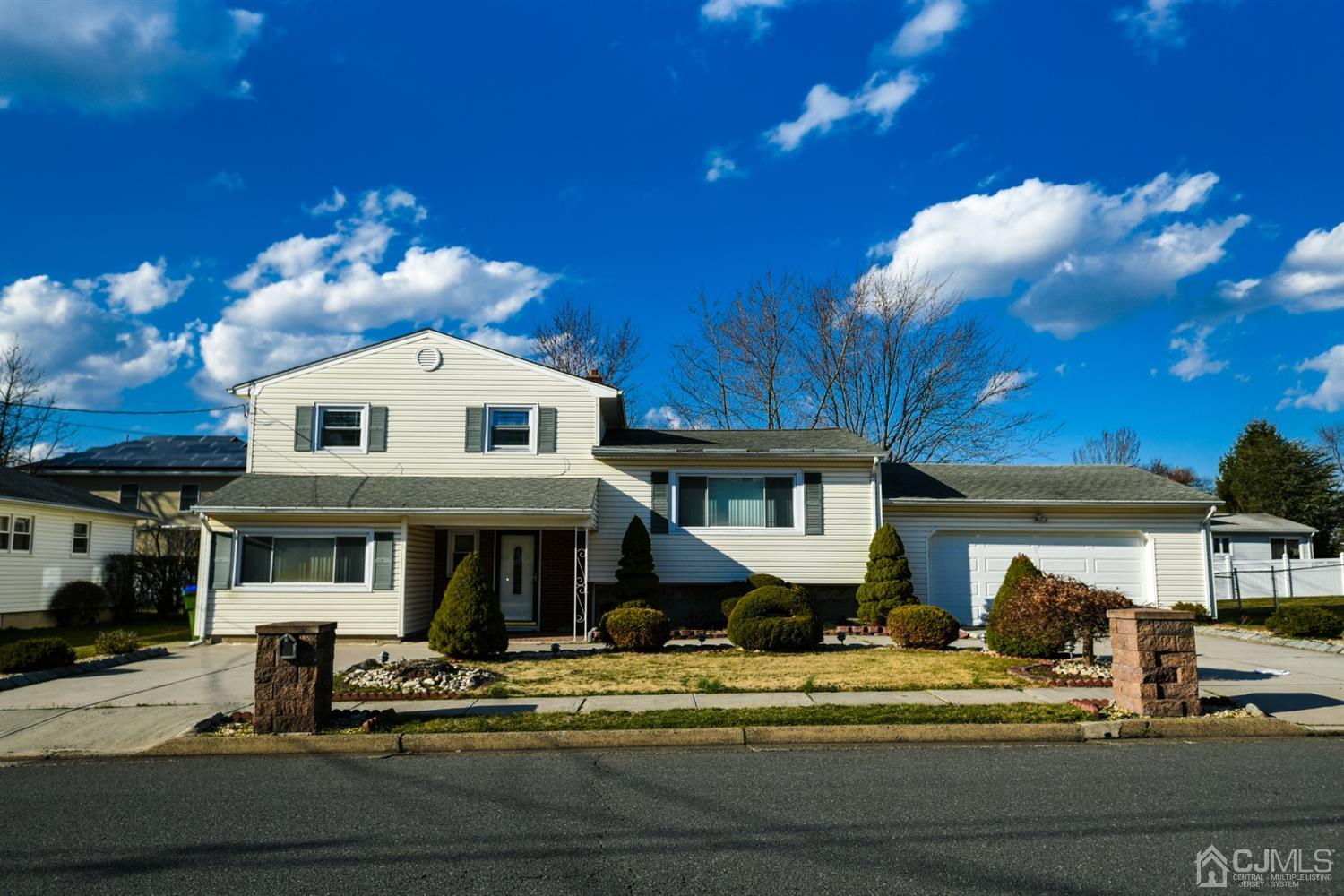 107 Calvert Avenue East Edison, NJ 08820 - Photo 1 of 28 a front view of a house with a yard