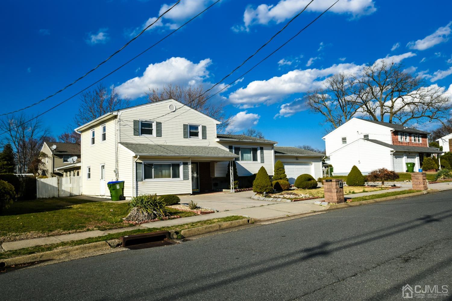 107 Calvert Avenue East Edison, NJ 08820 - Photo 2 of 28 a front view of a house with a yard