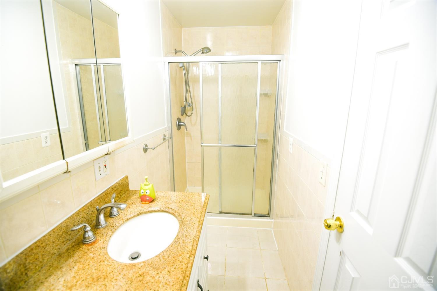 107 Calvert Avenue East Edison, NJ 08820 - Photo 12 of 28 a bathroom with a granite countertop sink and a mirror