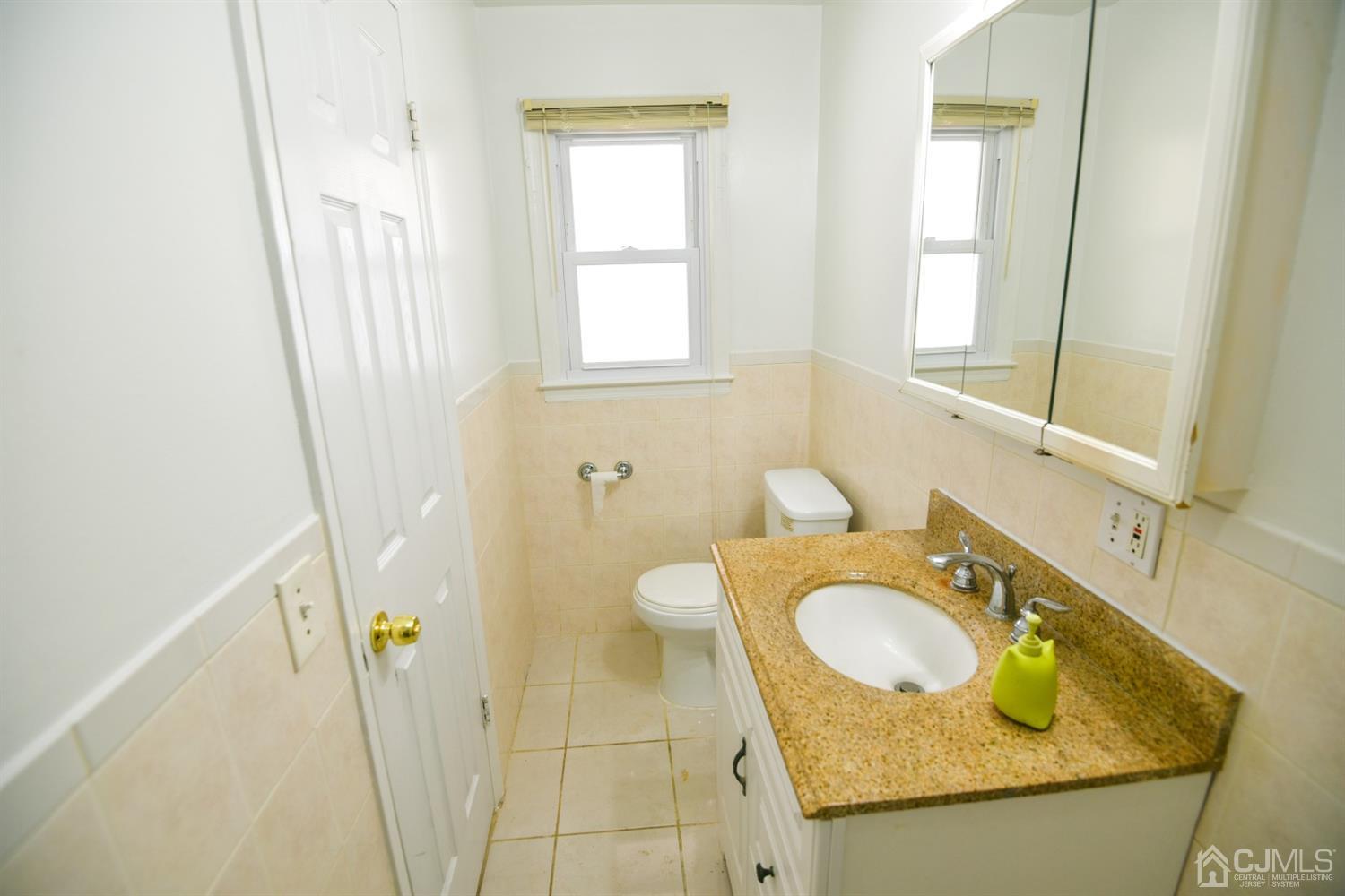 107 Calvert Avenue East Edison, NJ 08820 - Photo 13 of 28 a bathroom with a granite countertop sink and a mirror