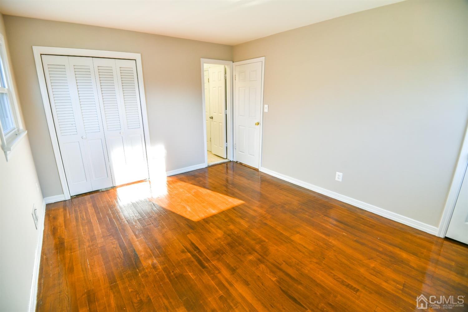 107 Calvert Avenue East Edison, NJ 08820 - Photo 14 of 28 a view of an empty room with wooden floor