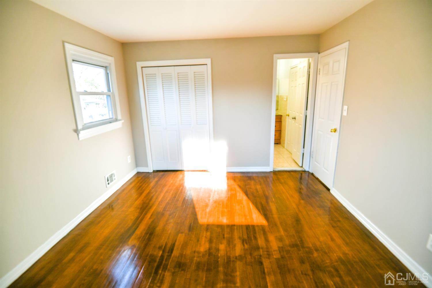 107 Calvert Avenue East Edison, NJ 08820 - Photo 16 of 28 a view of empty room with wooden floor
