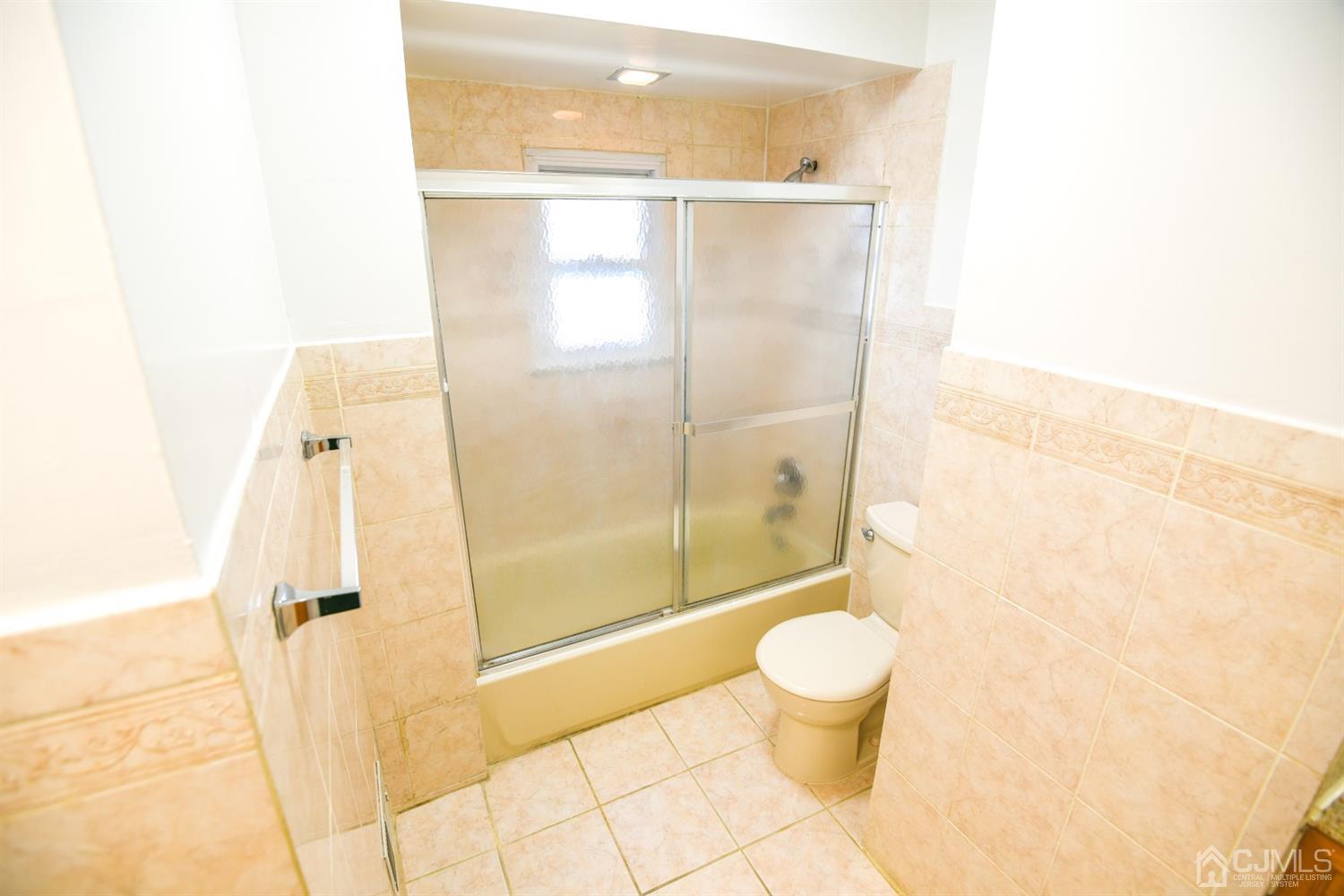107 Calvert Avenue East Edison, NJ 08820 - Photo 17 of 28 a bathroom with a granite countertop shower a toilet and a sink