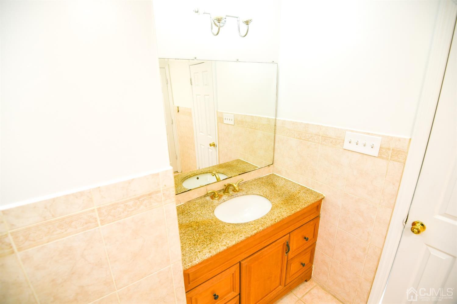 107 Calvert Avenue East Edison, NJ 08820 - Photo 18 of 28 a bathroom with a sink and a mirror