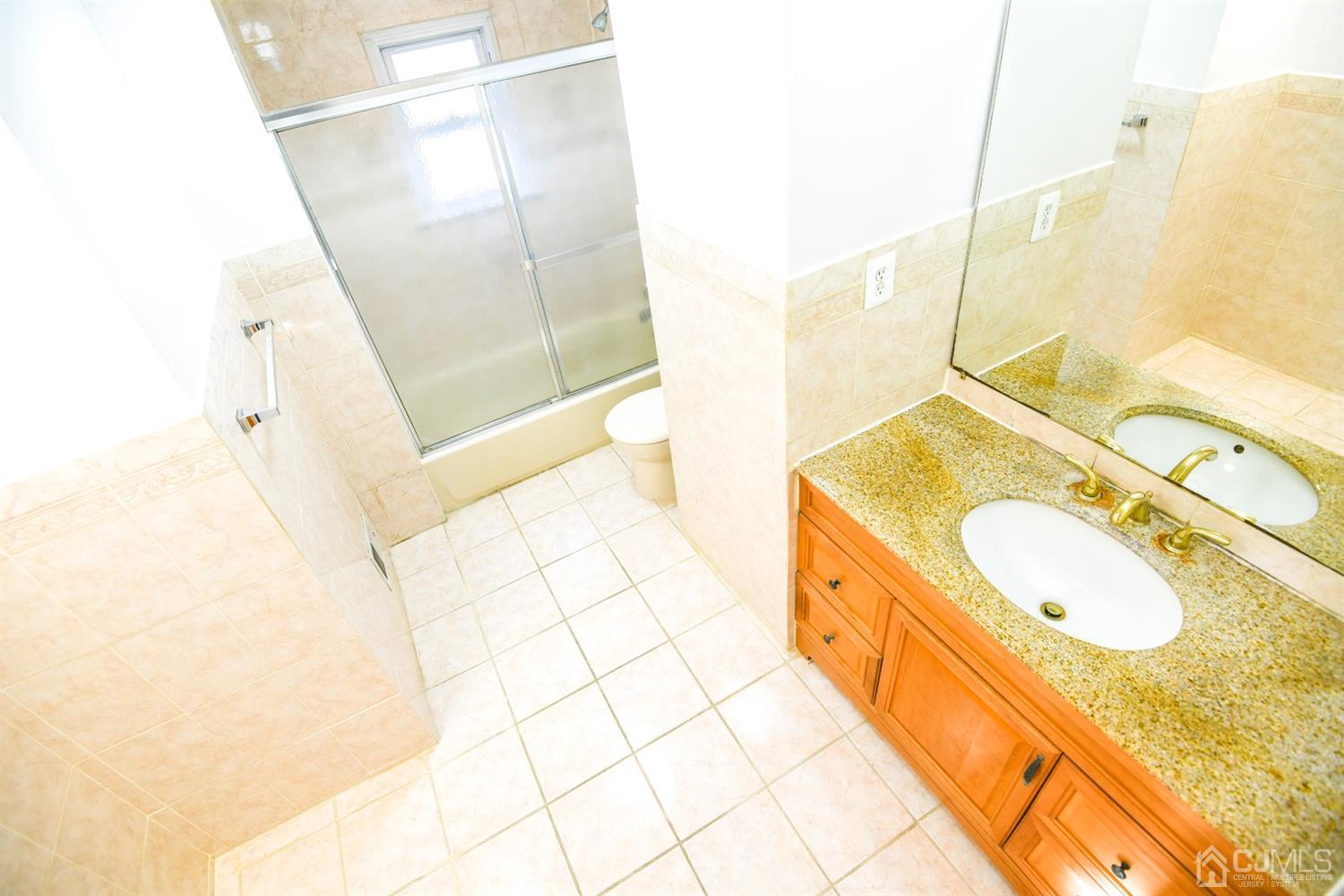 107 Calvert Avenue East Edison, NJ 08820 - Photo 19 of 28 a bathroom with a double vanity sink and mirror