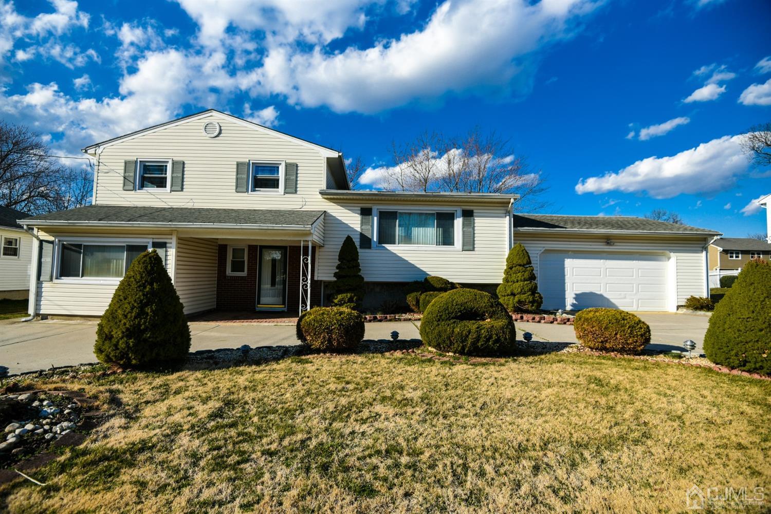 107 Calvert Avenue East Edison, NJ 08820 - Photo 4 of 28 a front view of a house with a yard