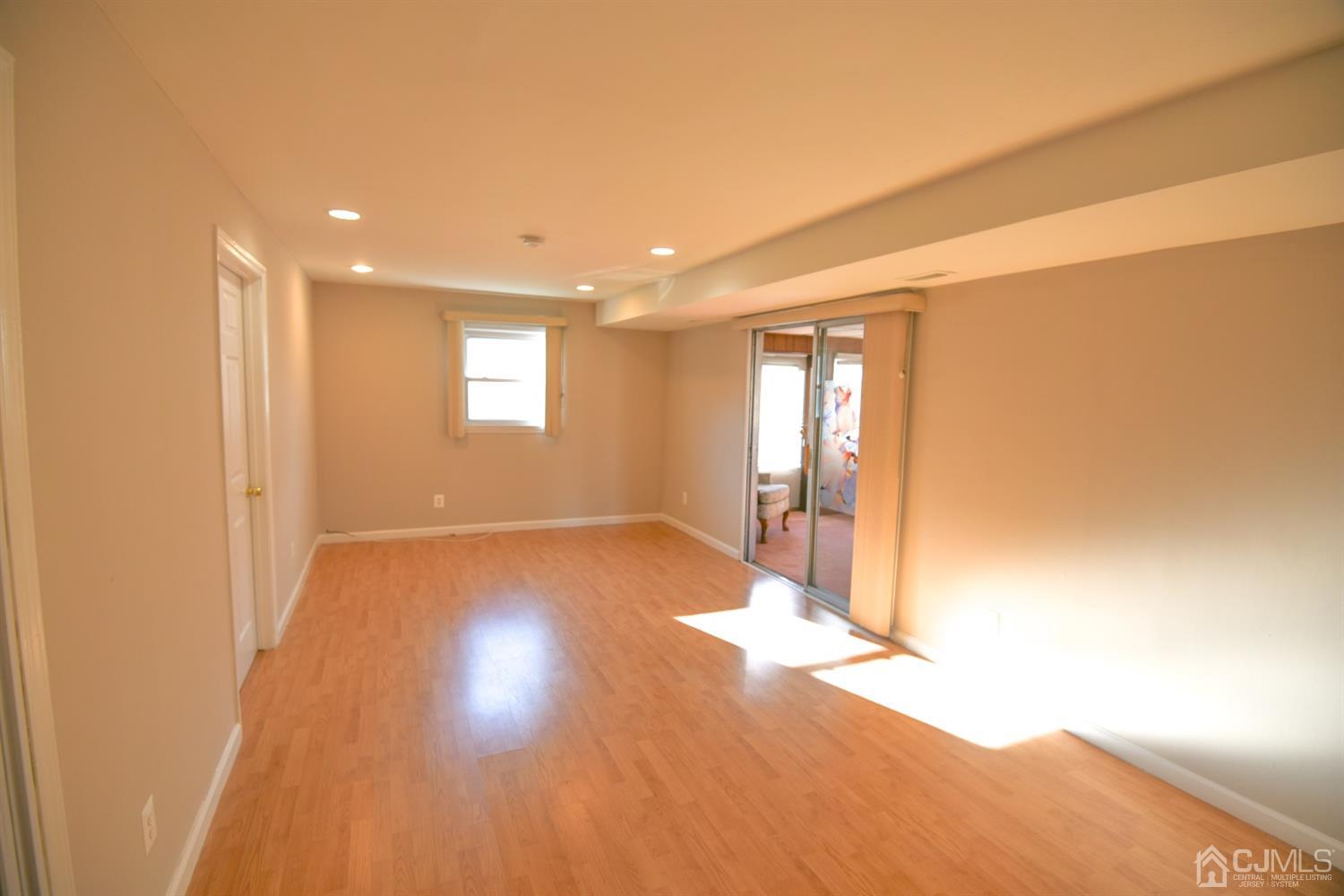 107 Calvert Avenue East Edison, NJ 08820 - Photo 8 of 28 a view of a livingroom with wooden floor and a window