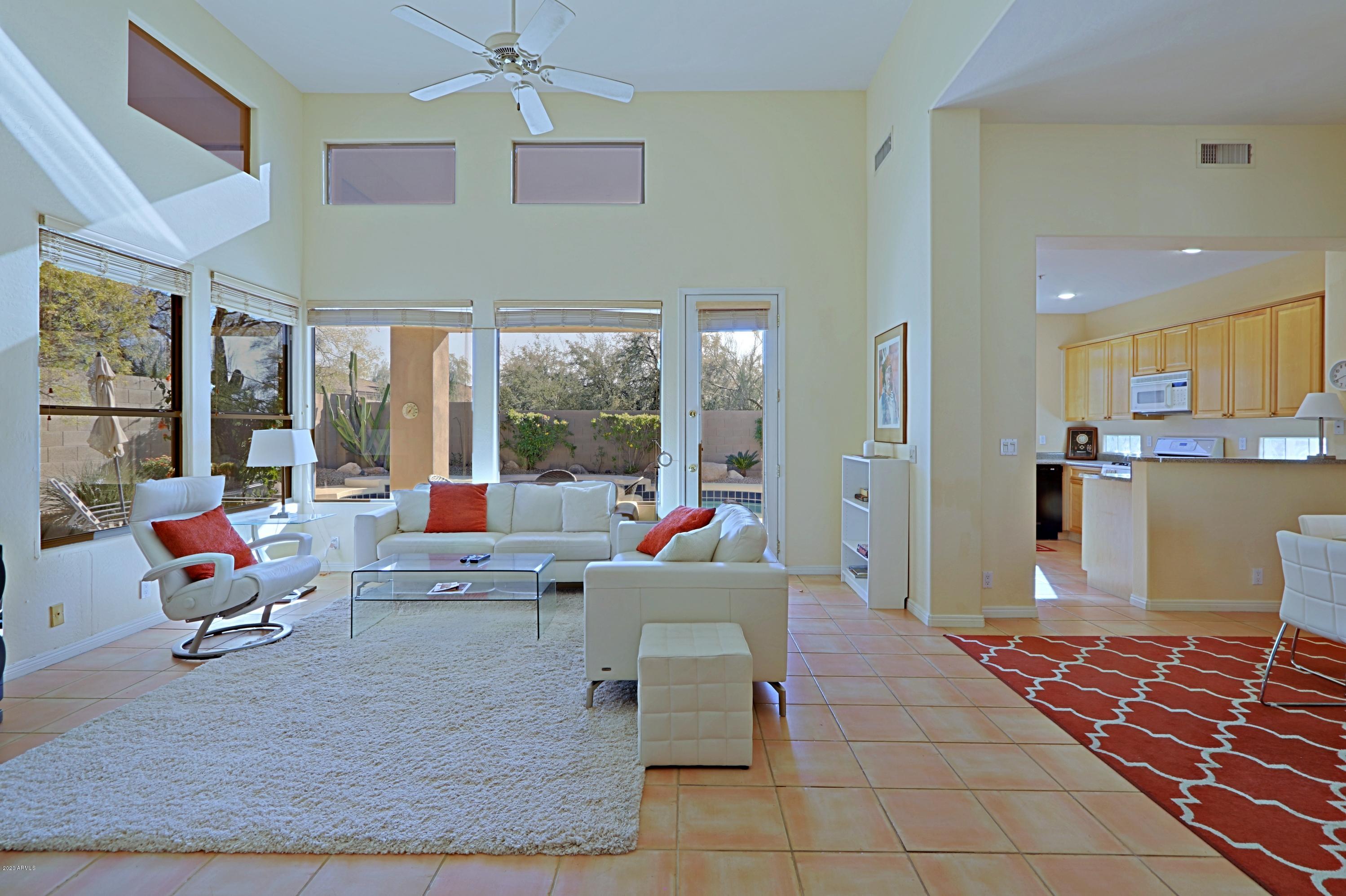 6803 East Eagle Feather Road Scottsdale, AZ 85266 - Photo 5 of 67 a living room with furniture and a large window