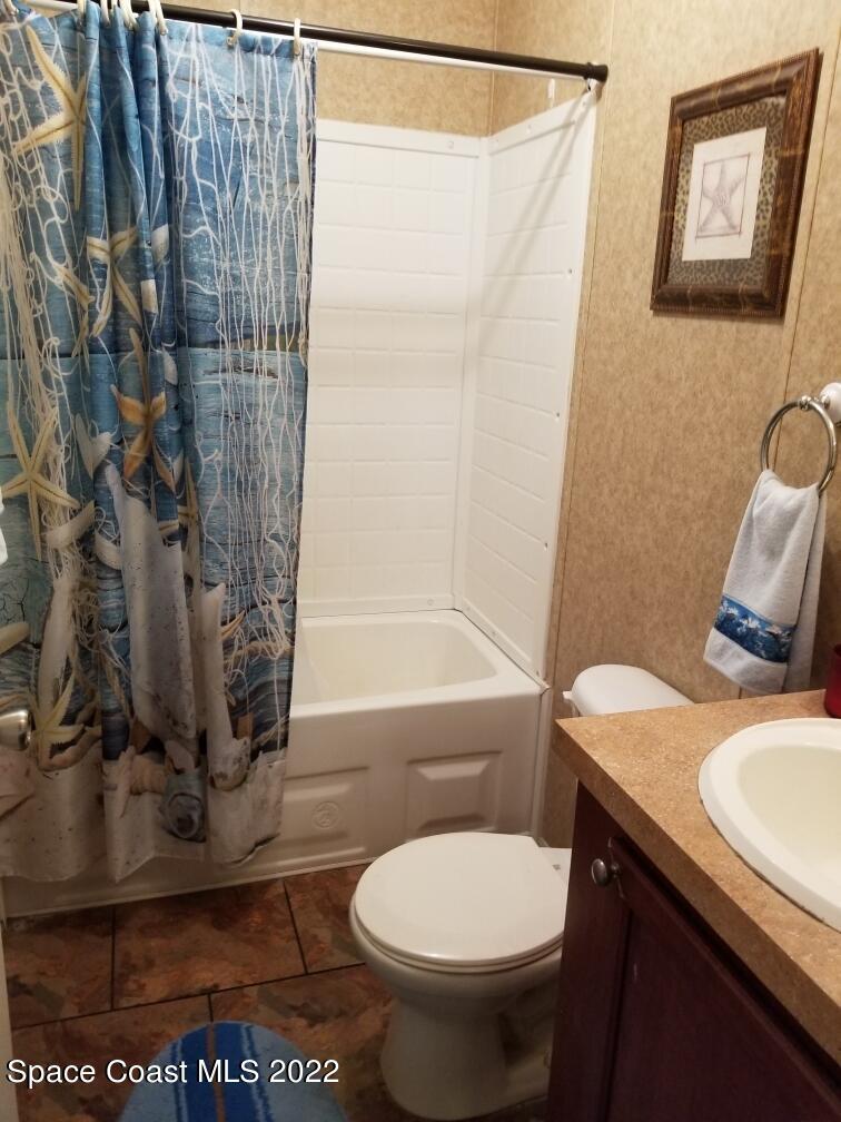 4051 Fountain Palm Road Cocoa, FL 32926 - Photo 14 of 25 a bathroom with a sink toilet and shower