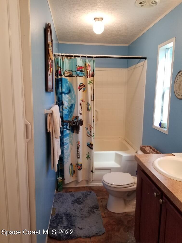 4051 Fountain Palm Road Cocoa, FL 32926 - Photo 16 of 25 a bathroom with a toilet a sink and a shower