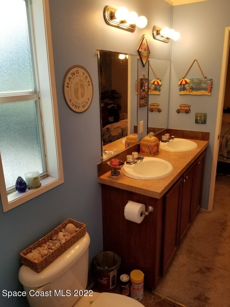 4051 Fountain Palm Road Cocoa, FL 32926 - Photo 17 of 25 a bathroom with a sink and a mirror