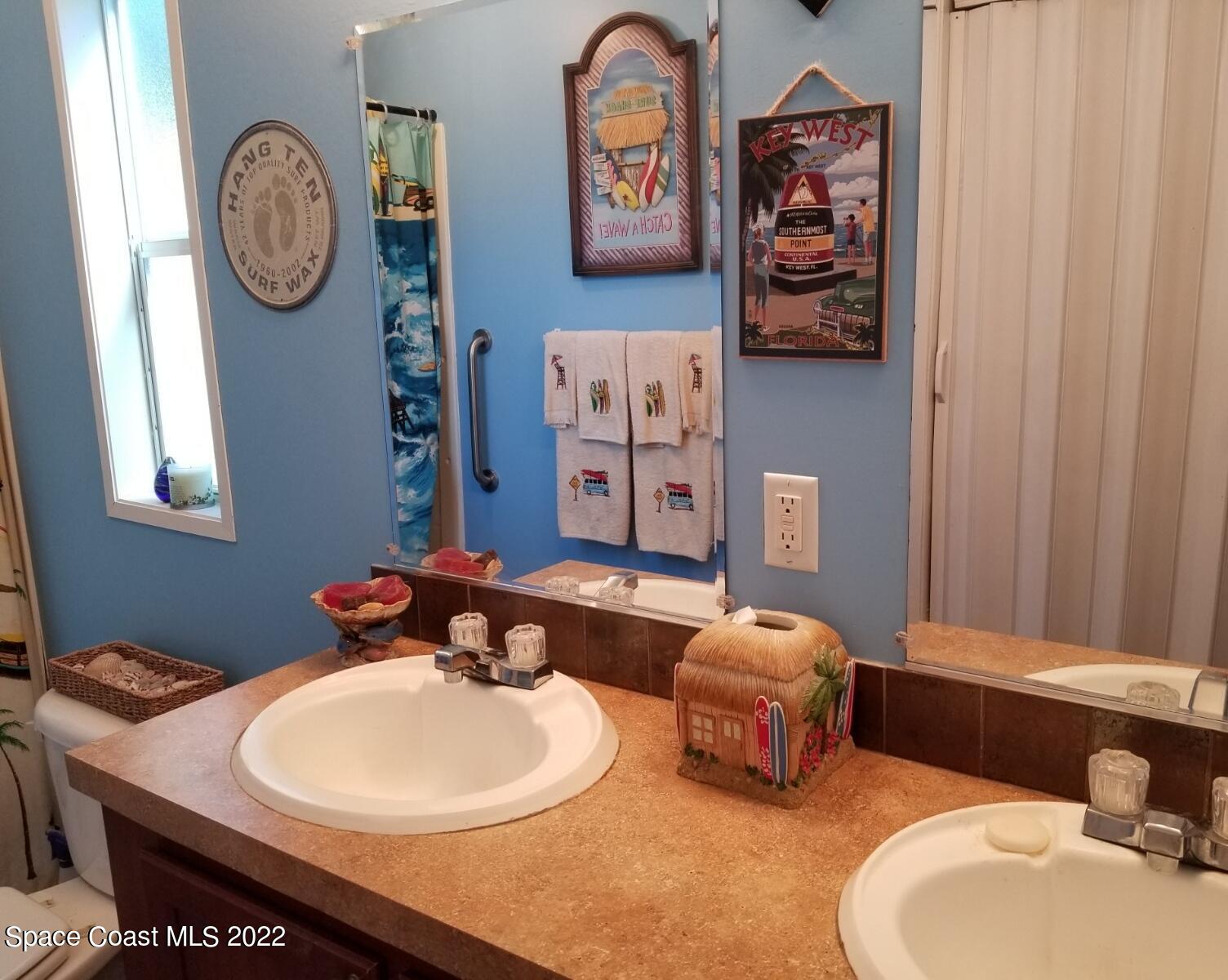 4051 Fountain Palm Road Cocoa, FL 32926 - Photo 18 of 25 a bathroom with a sink and a mirror
