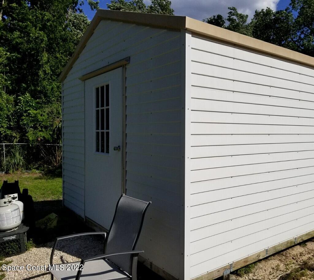 4051 Fountain Palm Road Cocoa, FL 32926 - Photo 22 of 25 a view of backyard of a house with seating space