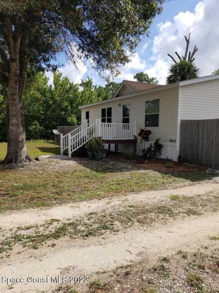 4051 Fountain Palm Road Cocoa, FL 32926 - Photo 23 of 25 a view of a house with a yard and sitting area