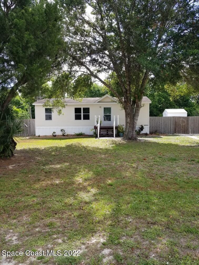 4051 Fountain Palm Road Cocoa, FL 32926 - Photo 3 of 25 a view of a house with a yard and sitting area