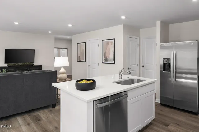 a kitchen with a sink a counter space and stainless steel appliances