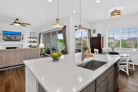 a kitchen with a sink a counter and chairs