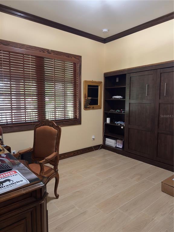 842 Hunting Club Avenue Clewiston, FL 33440 - Photo 12 of 34 a view of a workspace with furniture and a window