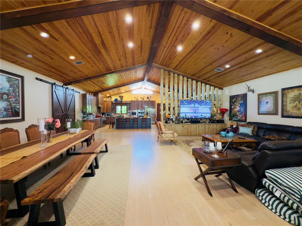 842 Hunting Club Avenue Clewiston, FL 33440 - Photo 2 of 34 a living room with furniture a flat screen tv and a large window