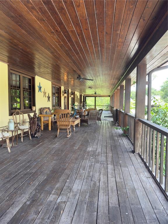 842 Hunting Club Avenue Clewiston, FL 33440 - Photo 23 of 34 a living room with lots of furniture hardwood floor and large windows