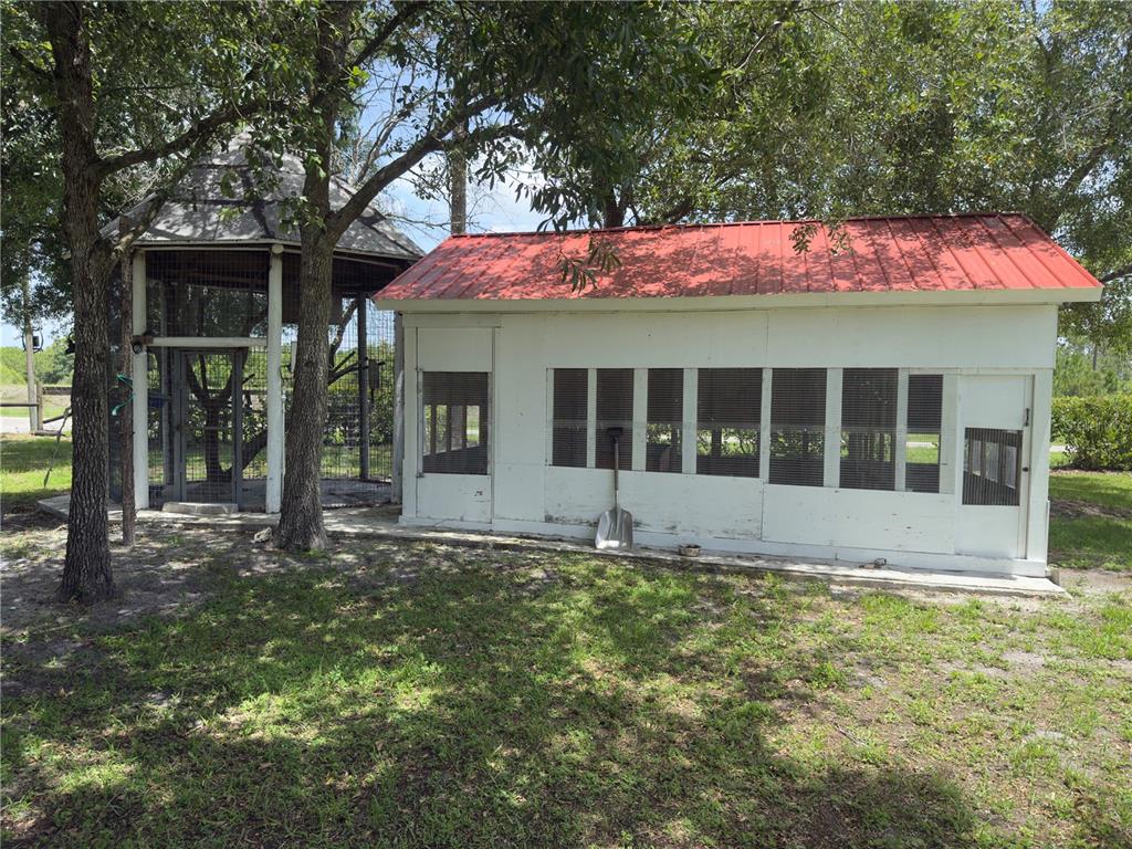 842 Hunting Club Avenue Clewiston, FL 33440 - Photo 25 of 34 a view of a house with a yard