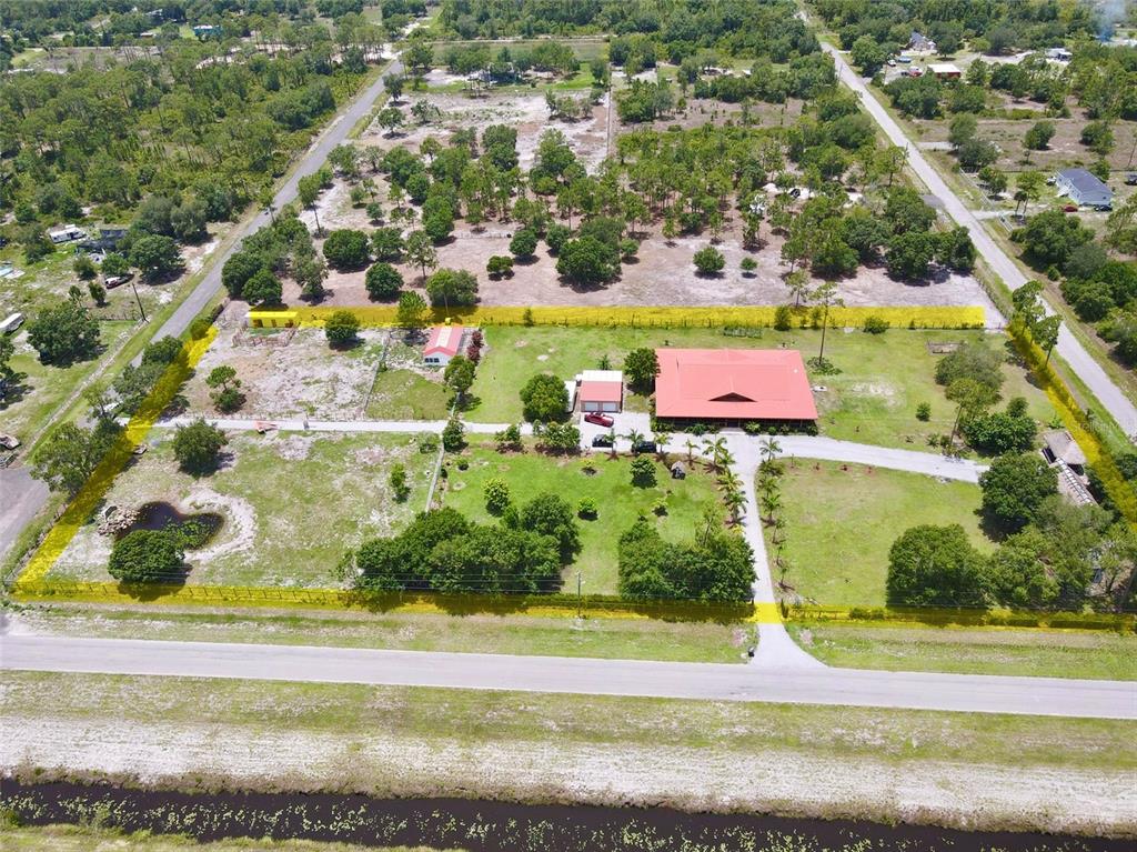 842 Hunting Club Avenue Clewiston, FL 33440 - Photo 32 of 34 an aerial view of residential houses with outdoor space and trees