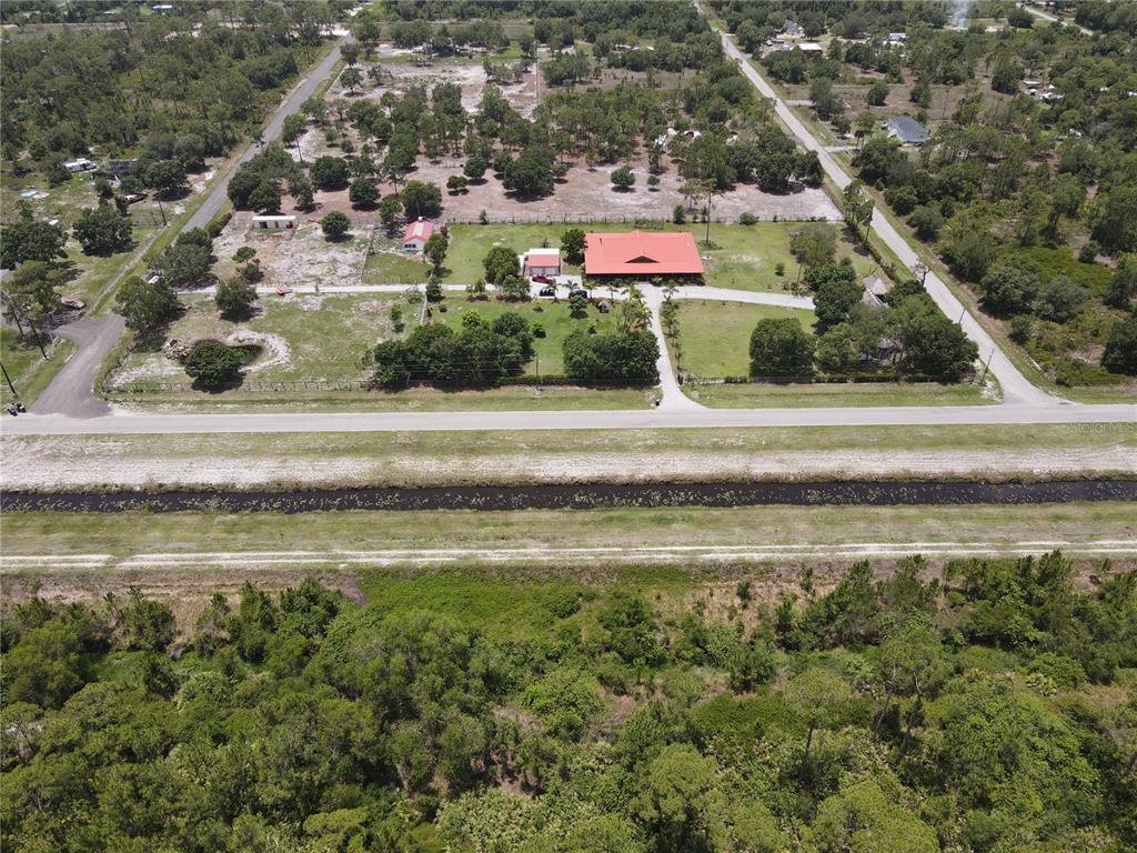 842 Hunting Club Avenue Clewiston, FL 33440 - Photo 34 of 34 a aerial view of a house with a yard and lake view