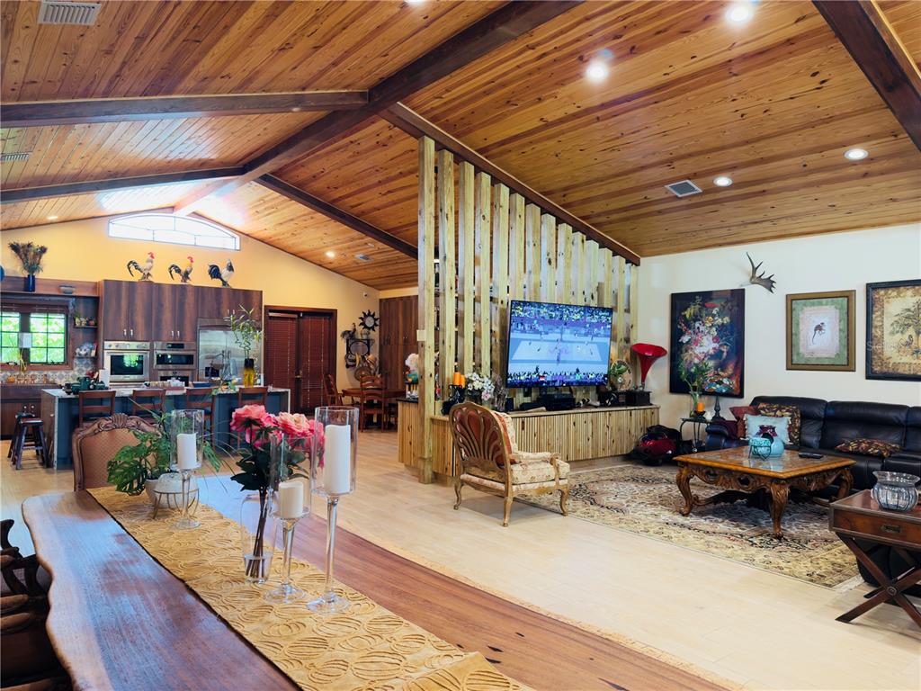 842 Hunting Club Avenue Clewiston, FL 33440 - Photo 4 of 34 a living room with lots of furniture and a kitchen view