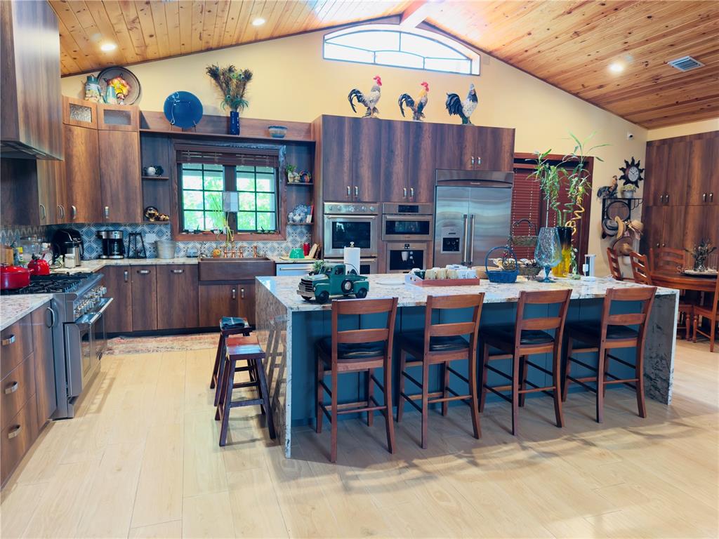 842 Hunting Club Avenue Clewiston, FL 33440 - Photo 6 of 34 a dining hall with furniture a large window and a sink