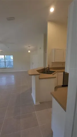 a view of a refrigerator a sink and dishwasher with wooden floor