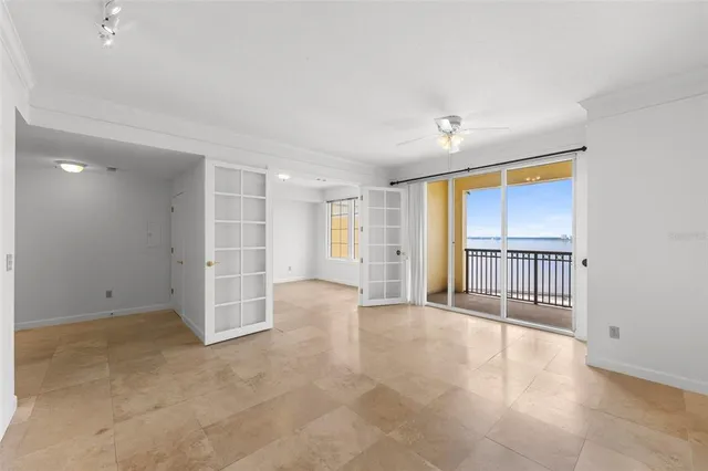 a view of a big room with an empty space and wooden floor