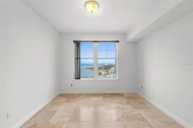 a bathroom with a granite countertop sink a toilet a mirror and shower
