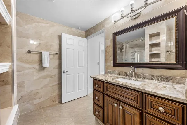 a living room with furniture fireplace and large windows