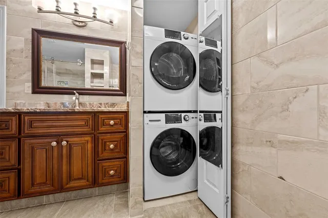 a kitchen with stainless steel appliances granite countertop a stove a sink dishwasher and microwave with wooden floor