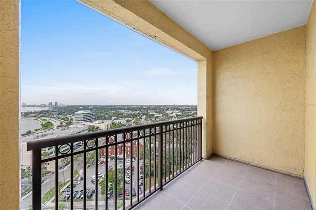 an empty room with windows and cabinet