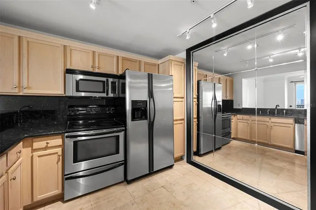 an empty room with windows and cabinet